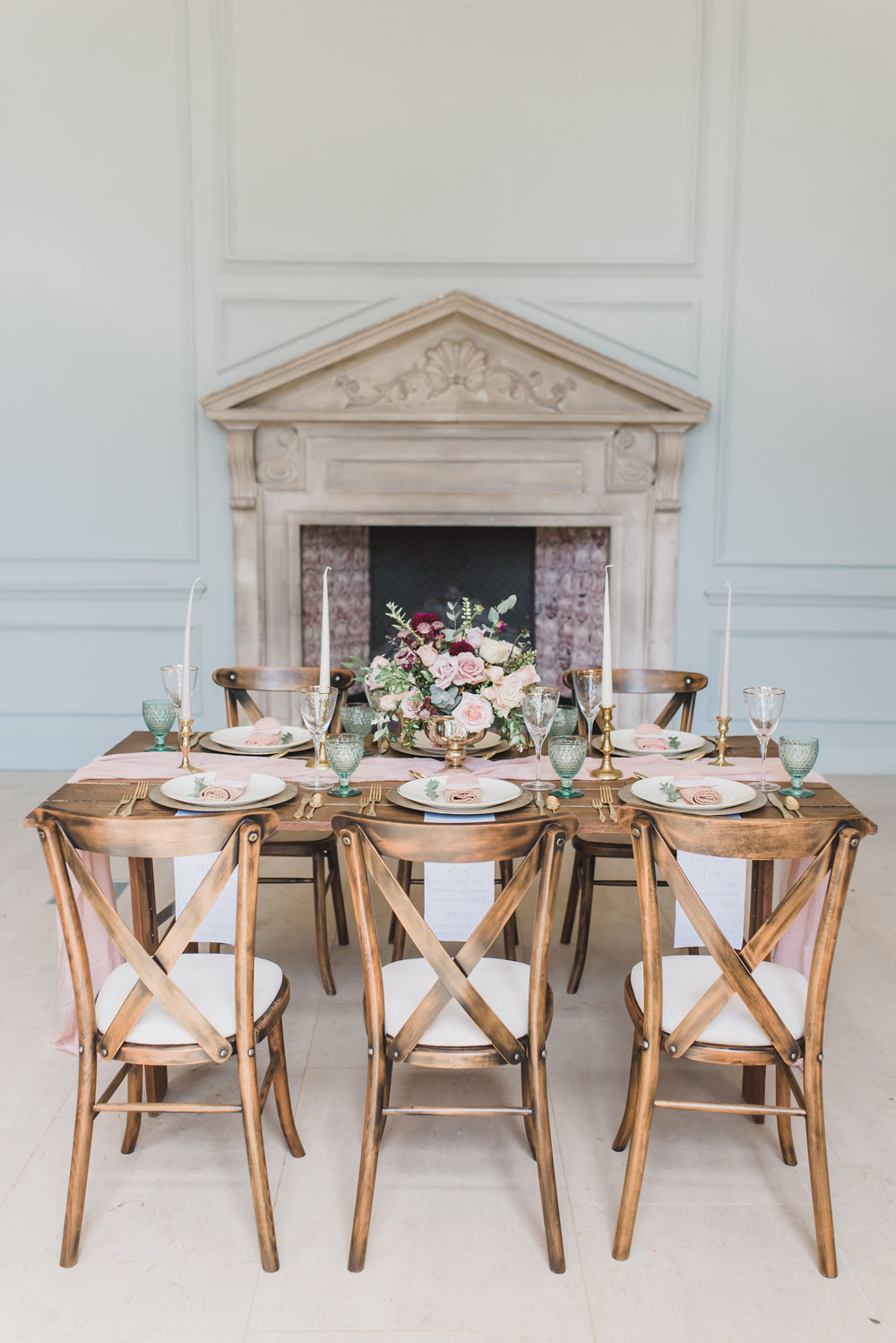 Elegant wedding inspiration in English country mansion Shaw House. Jewel toned tablescape, wedding tablescape, gold and colourful wedding table styling, jewel tone bridal bouquet, sage green and pink colour scheme, calligraphy place names, wedding table stationery, crossback chairs wedding