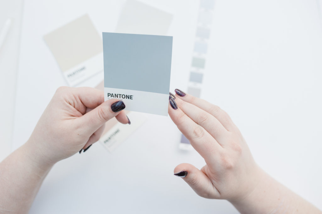 Lady holding colour palette for luxury brand design 