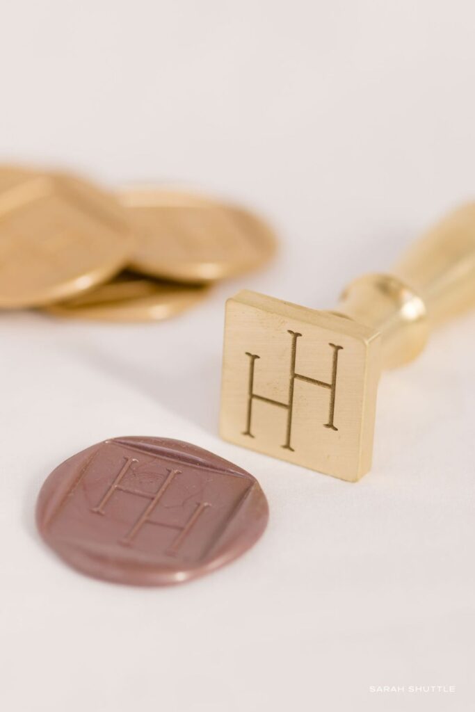 Bespoke square wax seal stamp, designed for a fine art luxury wedding photographer brand identity.